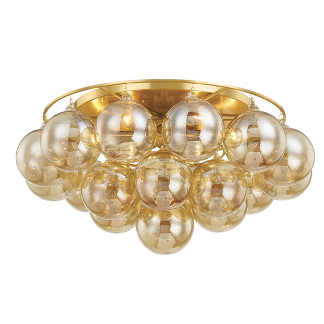 Gorgeous champagne glass globes are clustered around an elegant Aged Brass frame to create a statement piece that is...