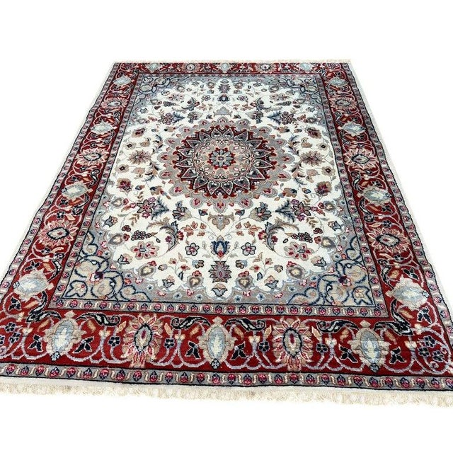 This hand knotted pile rug is crafted from a blend of wool and silk materials. The primary color palette features soft...