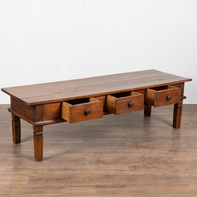 19th-century French walnut coffee table featuring a deep, richly aged patina and clean, classic lines. The simple form...