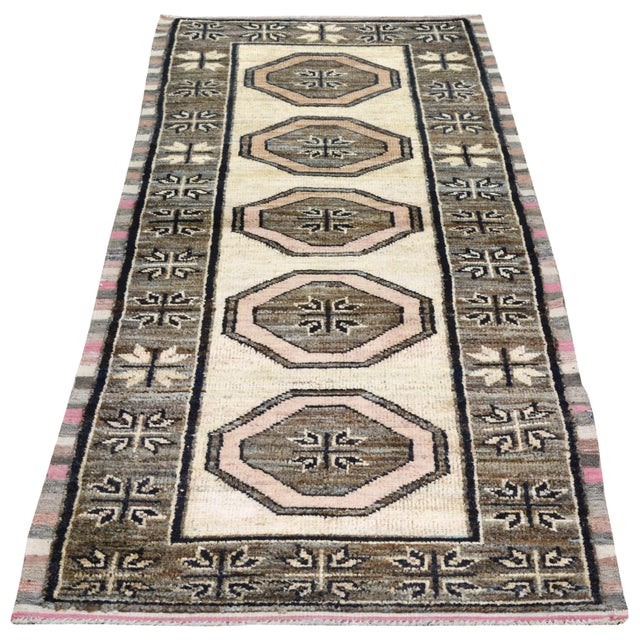 Hand-knotted with care using traditional rug making techniques, this wool rug blends timeless craftsmanship with a modern...