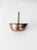 Antique deep-sided copper pan featuring a rounded form with tall walls and a long brass handle pierced with a hanging...