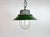Industrial hanging lamp manufactured in Poland during the 1960s. It features a green enamel shade with a white enamel...