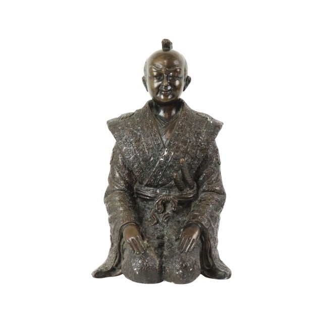 A beautiful and detailed bronze sculpture of a kneeling Japanese warrior or samurai, dating from the second half of the...