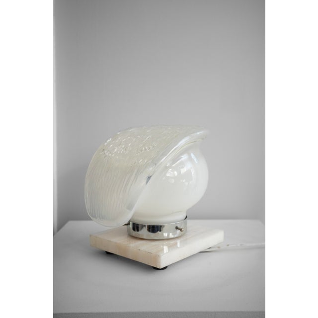 Murano glass table lamp from the 1980s, made in Italy. The lamp is made of hand-blown Murano glass with a structured shape...