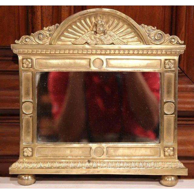 Decorate a powder room, entry, or intimate wall space with this charming antique French repoussé brass mirror, crafted...