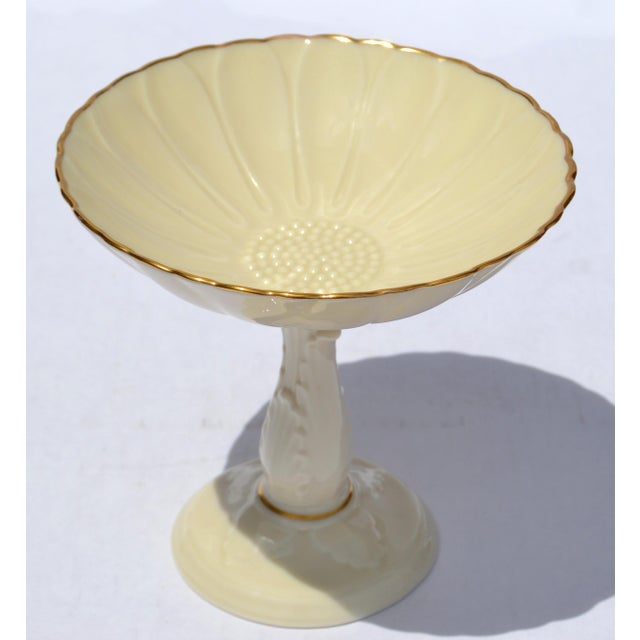 1978 Lenox Charleston Compote Pedestal Dish in tan fine bone china with a sunflower embossed design and gold trim. The...