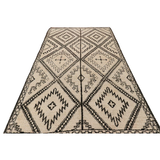 Hand-knotted in wool and originating from Morocco circa 1950-1960, this 6x12 vintage Moroccan rug is an extremely rare...