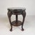 Elegant table from the early 20th century with a beautifully decorated mahogany base and a luxurious marble top. This...