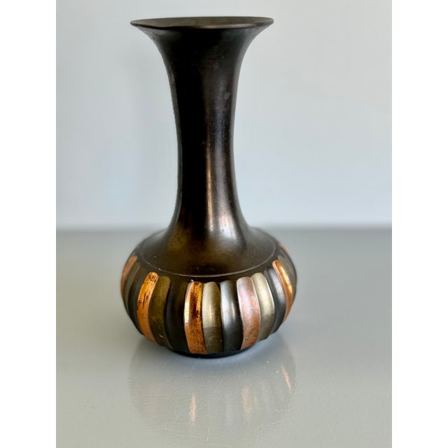 This small vintage vase is made of brass and copper. It doesn't have any markings so I am not sure when it dates back to....