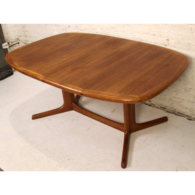 This is a stunning teak dining table by Dyrlund. This an odd table, you rarely see a danish dining table in an oval shape....