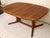This is a stunning teak dining table by Dyrlund. This an odd table, you rarely see a danish dining table in an oval shape....