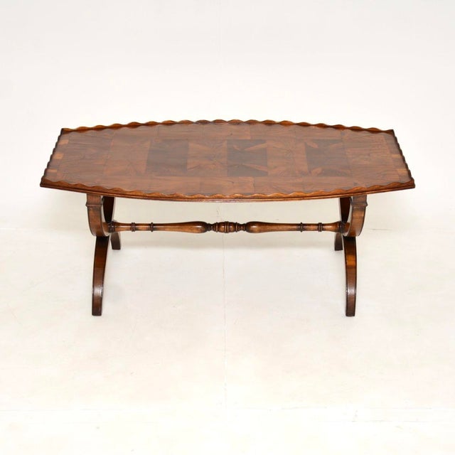 A gorgeous antique yew wood oyster veneer coffee table. It is in the Regency style, this was made in England and dates...