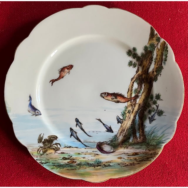 Pair antique late 19th century French Limoges porcelain plates. Decorated with hand painted fish, a crab and sea shell in...