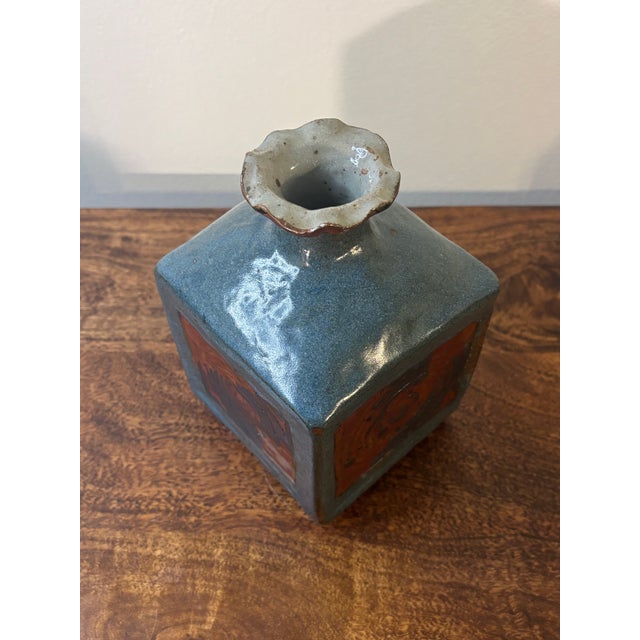 A sculptural mid-century modern studio ceramic vase with a square base rising into a domed body and ruffled lip, giving...