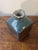 A sculptural mid-century modern studio ceramic vase with a square base rising into a domed body and ruffled lip, giving...
