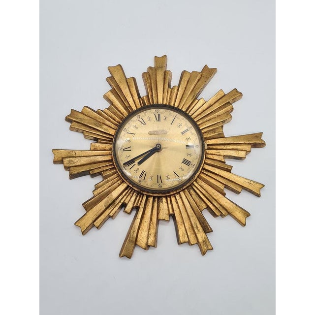 An original decorative wall clock bearing the “Electrica” signature, crafted in the striking form of a sunburst. The...