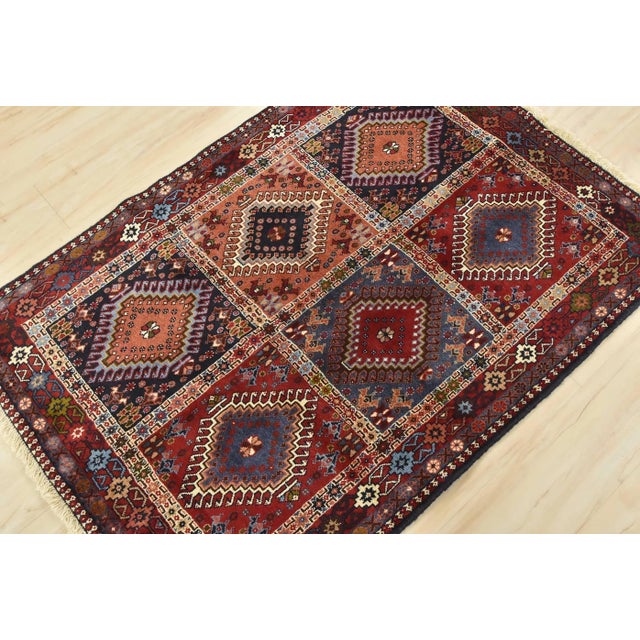 An authentic vintage tribal Yalameh rug hand-knotted with fine wool and natural dyes. This finely woven nomadic rug...