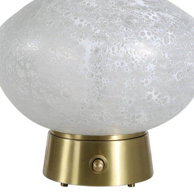 Featuring a softly luminous lunar glass body and dramatically tapered neck, this table lamp brings an atmospheric glow and...