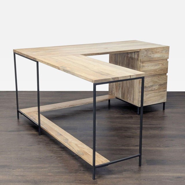 This modern L-shaped desk from West Elm features a natural wood finish and a sturdy black metal frame. It has three...