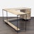 This modern L-shaped desk from West Elm features a natural wood finish and a sturdy black metal frame. It has three...