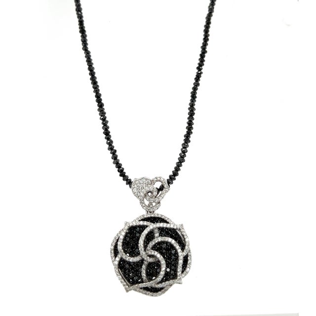 This beautiful necklace has a gorgeous black and white diamond pendant in the shape of a flower. It has 2.12 carats of...