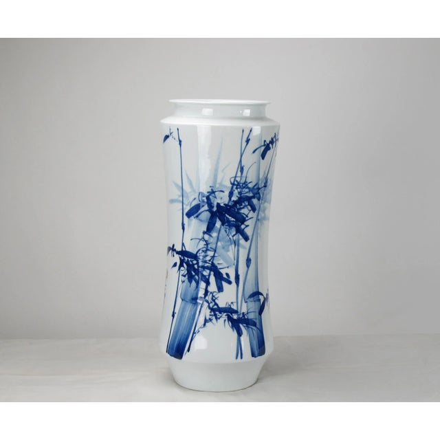 This modern blue & white porcelain vase was designed and made by Mr. Zhou, an artisan from Jingdezhen, an ancient city in...
