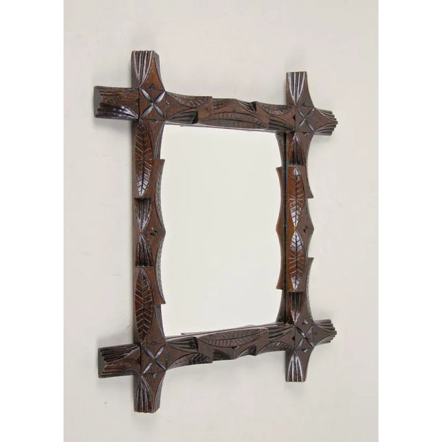 Lovely small Black Forest mirror from Austria, circa 1890. Artfully processed out of basswood, this frame shows unusual...