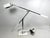 An iconic 1970's articulating chrome and white metal desk lamp designed by Robert Sonneman. The counter-balanced light is...