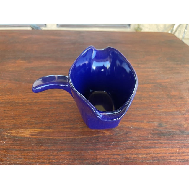 This is a vintage Frankoma gravy boat labeled number 6S. It is colbalt blue, has a handle, and two pouring spouts. It...