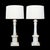each columnar lamp of Carrara marble with Tuscan style capital above a cylindrical standard resting on a cylindrical base...