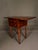 Beautifully crafted by the Davis Cabinet Company of Nashville, Tennessee, this American-made drop leaf side table...