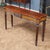 This Vintage Henkel Harris Mahogany Console, brought to you by Niagara Furniture, was manufactured using solid mahogany...