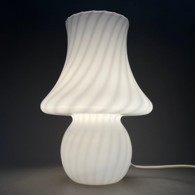 An iconic, single-piece mushroom-shaped table lamp in white opaline glass with a swirling spiral design, attributed to the...