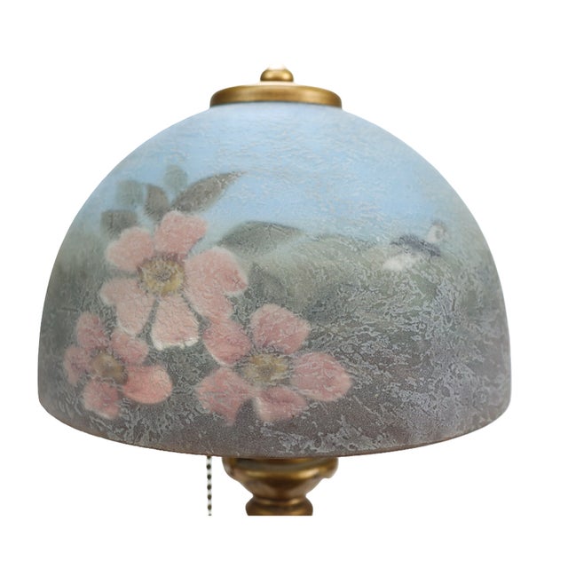 Antique Handel table lamp, circa 1910, with a domed chipped-ice glass shade and an ornate gilt-metal base. The shade is...