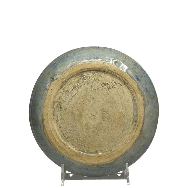 Hand-thrown stoneware plate by a studio potter, signed on the underside (mark partially legible, appears to end in “…man”...