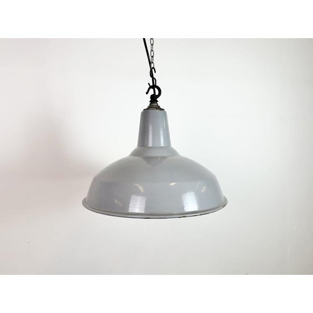 Industrial grey enamel factory pendant light made in united kingdom during the 1960s. White enamel inside the shade. Iron...