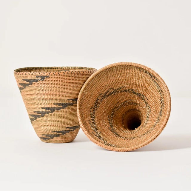 The Tutsi Tight Weave Basket with Lid from Rwanda epitomizes the artistry and tradition of the Tutsi community's weaving...