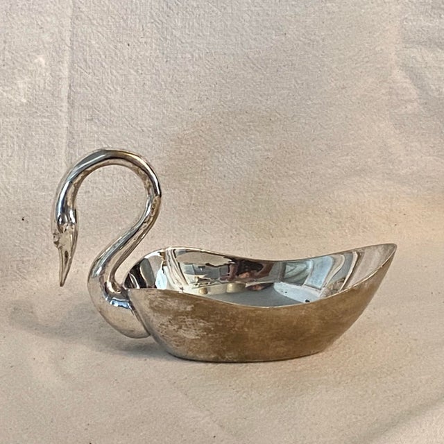 Silver plated set of swans to adorn your table. One bowl and 8 napkin Rings. Each napkin ring measures 2.75 x 2.25.