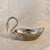 Silver plated set of swans to adorn your table. One bowl and 8 napkin Rings. Each napkin ring measures 2.75 x 2.25.