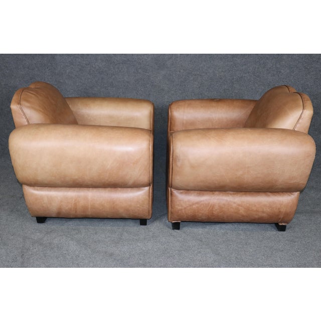 An exceptional pair of French Art Deco style moustache club chairs, professionally restored and reconstructed within the...