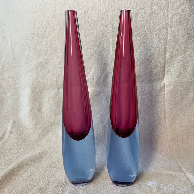 This is a pair of vintage mid-century Murano Sommerso art glass teardrop vases featuring a striking magenta or cranberry...
