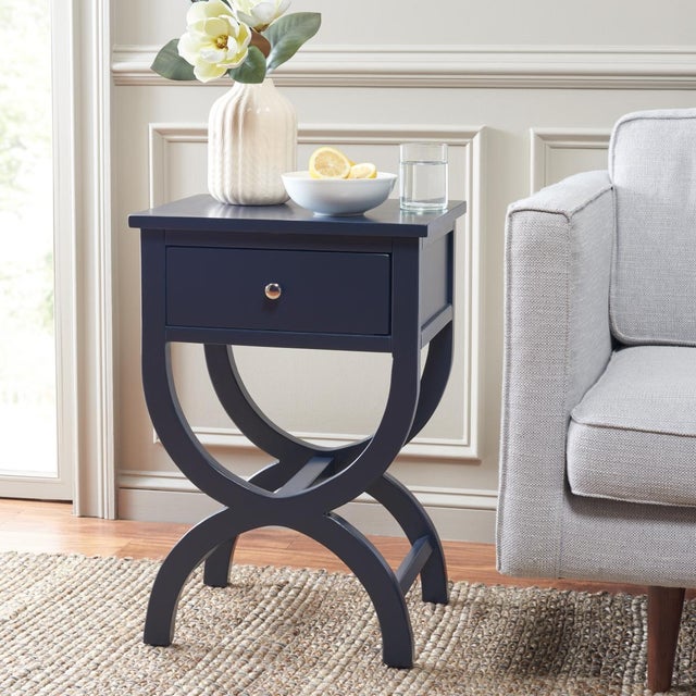 Introducing the Maxine Accent Table with Storage Drawer in a distinguished navy hue. Crafted from wood, MDF, and metal,...