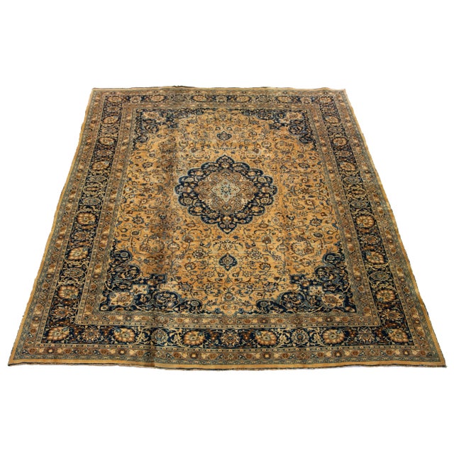 This wool rug boasts an exquisite antique Mashad hand-knotted texture. It features a deep light brown field with an...