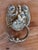 English brass door knocker cast as a lion's face with a finely combed mane, rounded ears and a textured beard. A plain...