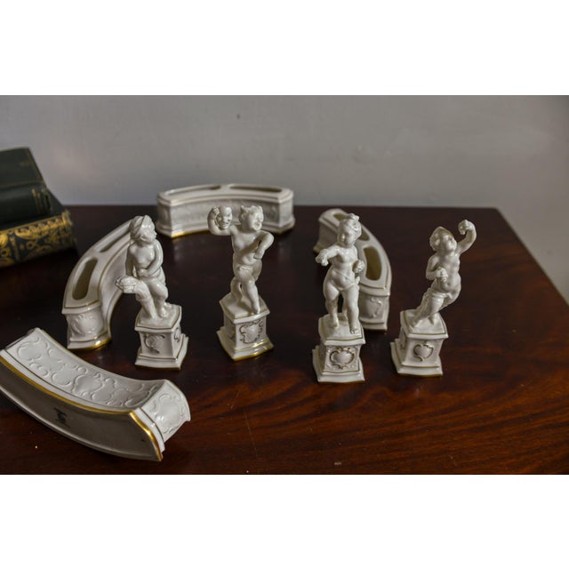 A complete eight piece porcelain garniture set designed by sculptor Carl Werner for the art department of Hutschenreuther...