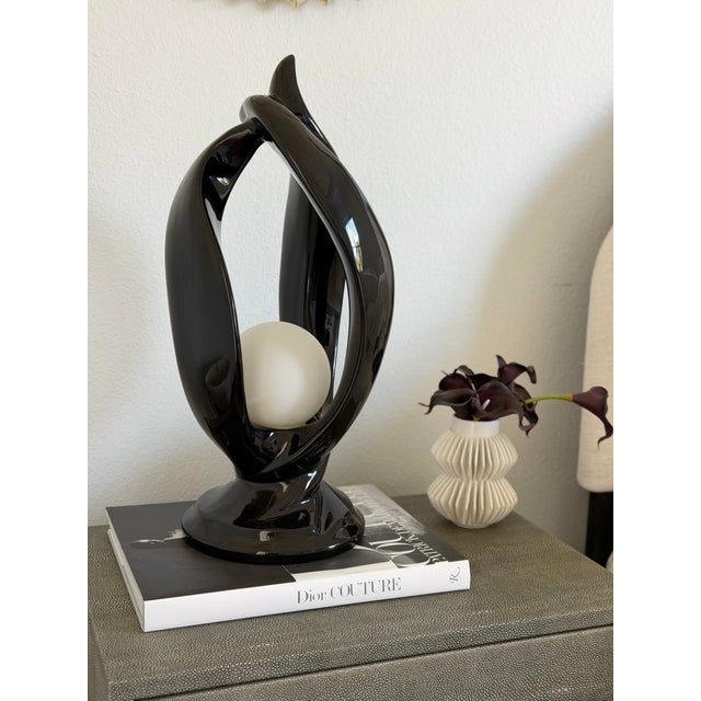 Sleek, abstract lamp from the late 20th century. These pieces were heavily utilized in postmodern and transitional...