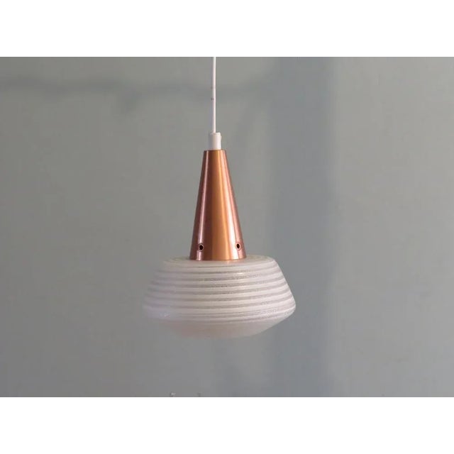 Small Scandinavian pendant with striped, etched glass chalice and copper cover. The lamp has the original black Bakelite...
