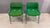 A striking pair of Mid-Century Modern conference chairs featuring vibrant green molded shells with matching upholstered...
