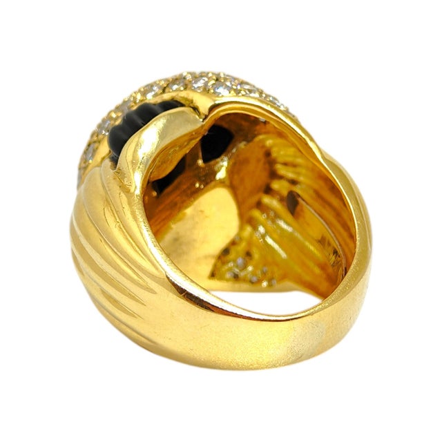 Vintage 18K yellow gold large domed cocktail ring with a stylized knot design, composed of pave set round brilliant cut...