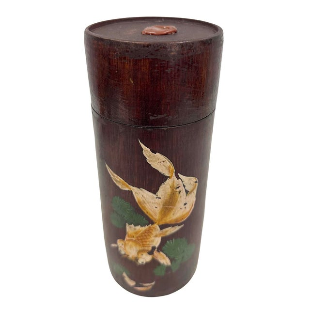 This is a antique Chinese hand-painted cylindrical tea caddy (chazutsu), crafted from natural bamboo. It features an...